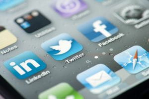 Three social media icons on iPhone screen