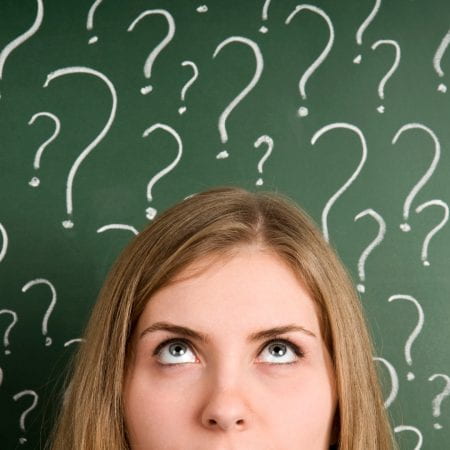 young woman surrounded by question marks