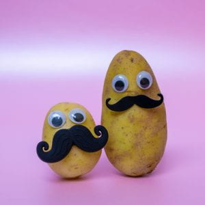 funny potato head with a face on a pink background