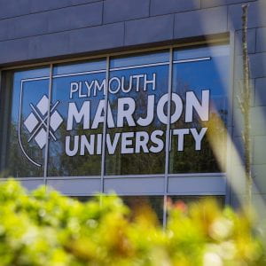 The logo on the main entrance of Plymouth Marjon University